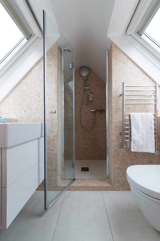 Inspiration for a small contemporary ensuite bathroom in Surrey with flat-panel cabinets, white cabinets, a wall mounted toilet, beige tiles, beige walls, ceramic flooring, grey floors, a hinged door, a single sink, a floating vanity unit, a vaulted ceiling, mosaic tiles and a console sink.