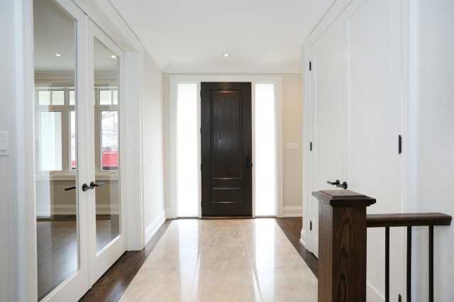 Traditional hallway in Toronto with beige walls and ceramic floors.