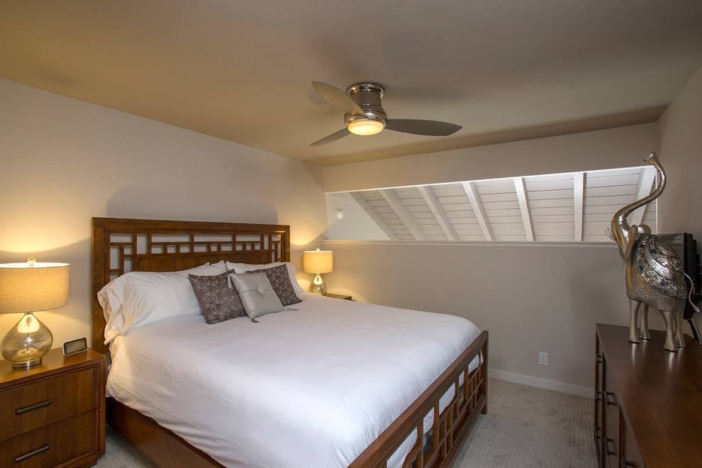 Photo of a mid-sized transitional loft-style bedroom in Hawaii with grey walls and carpet.