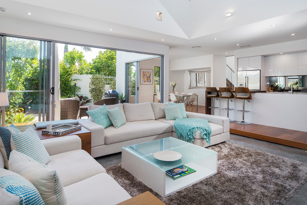 Beach style open concept living room in Gold Coast - Tweed with white walls.