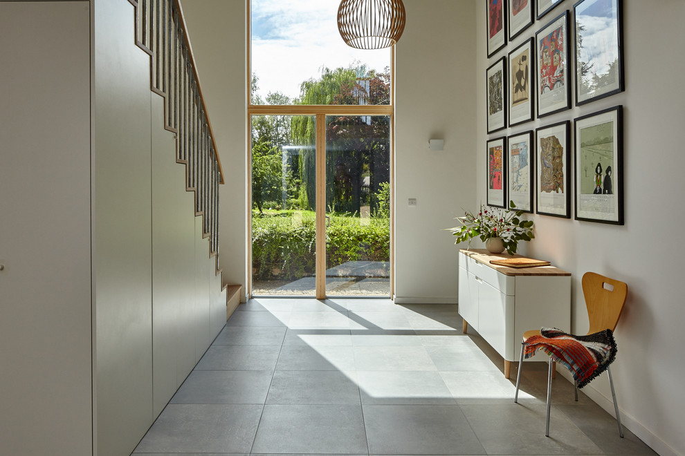 Photo of a transitional hallway in Other with white walls and grey floor.