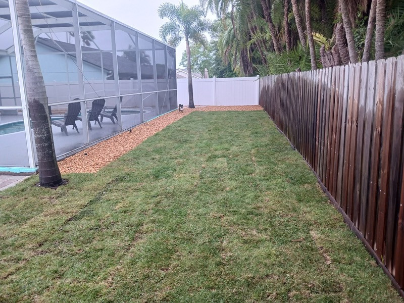 Photo of a backyard river rock landscaping.