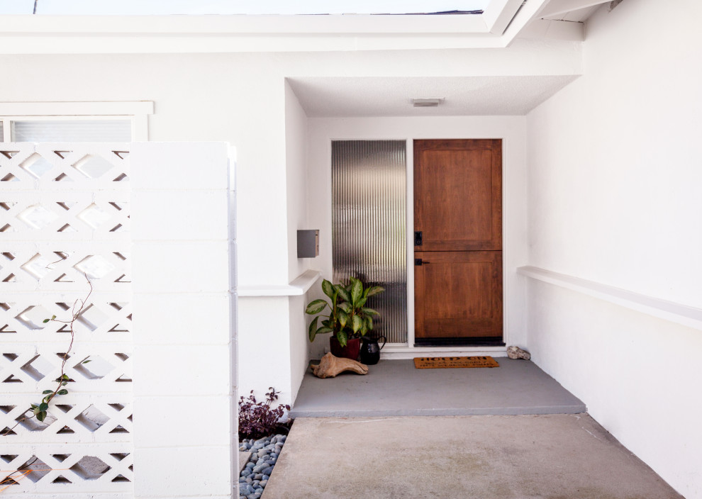 Mid-sized midcentury front door in Los Angeles with a dutch front door and a dark wood front door.