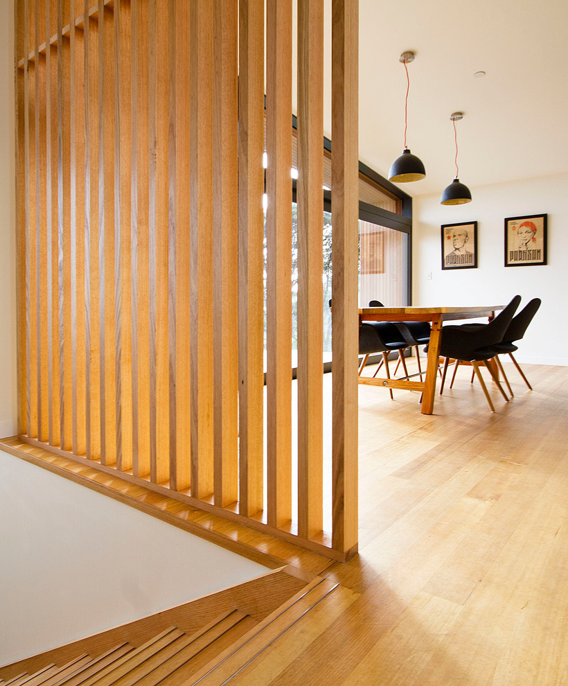This is an example of a Small beach style Wood Straight staircase in Auckland With Wood Risers and Wood Railing.