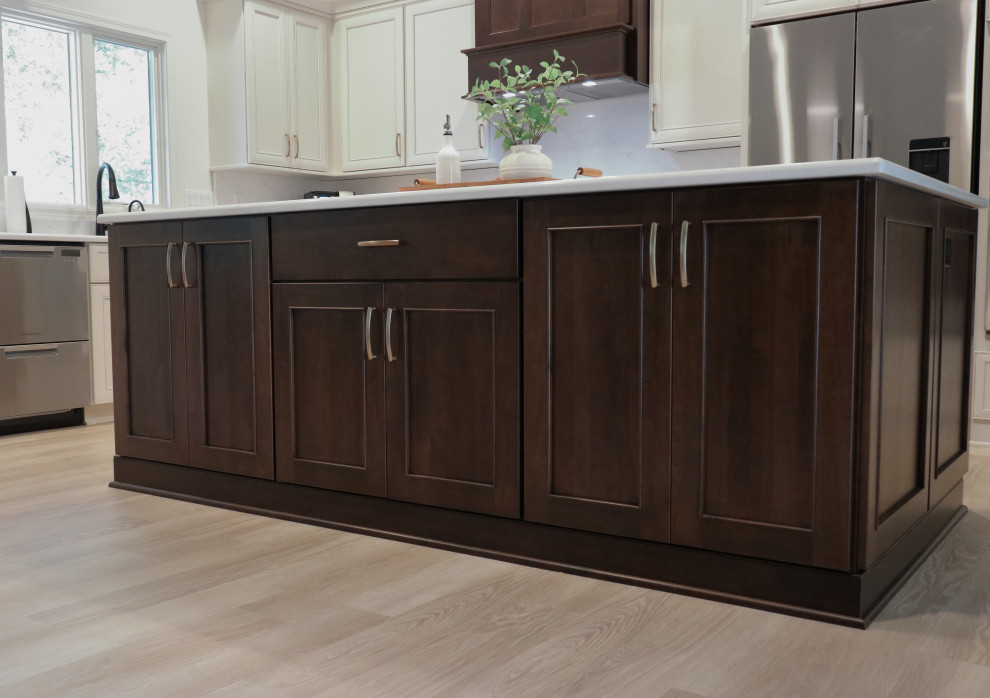 Inspiration for a large transitional l-shaped kitchen remodel with an undermount sink, recessed-panel cabinets, quartz countertops, white backsplash, quartz backsplash, stainless steel appliances and white countertops