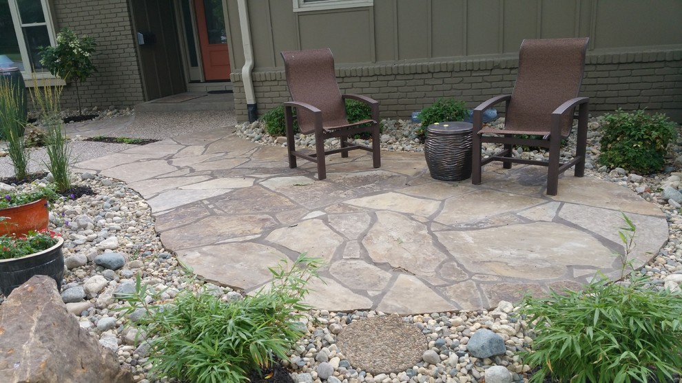 Photo of a small traditional front yard patio in Kansas City with natural stone pavers and no cover.