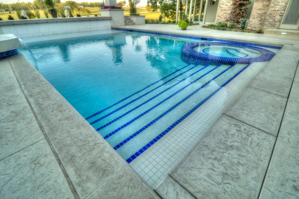 Inspiration for a large transitional backyard concrete paver and rectangular natural hot tub remodel in Cedar Rapids