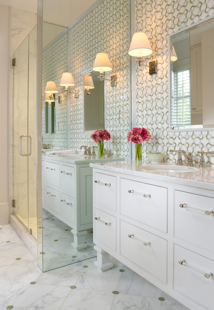 This is an example of a traditional bathroom in DC Metro with beaded inset cabinets, white cabinets, multi-coloured tile and marble floors.