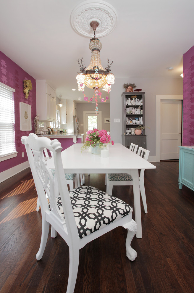 Inspiration for an eclectic dining room in Dallas with dark hardwood floors and pink walls.