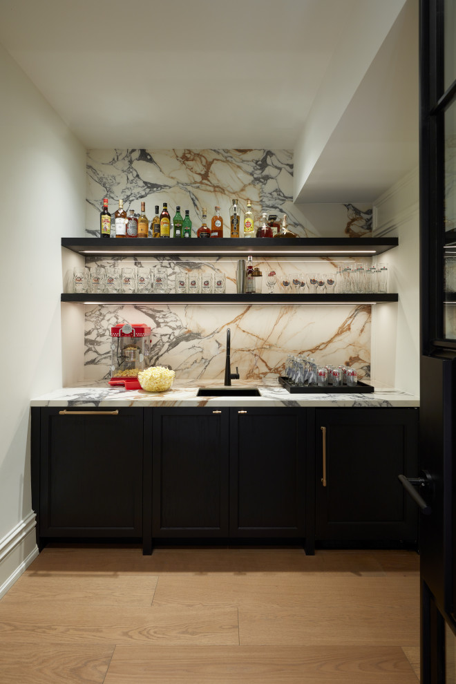 Example of a transitional home bar design in Toronto