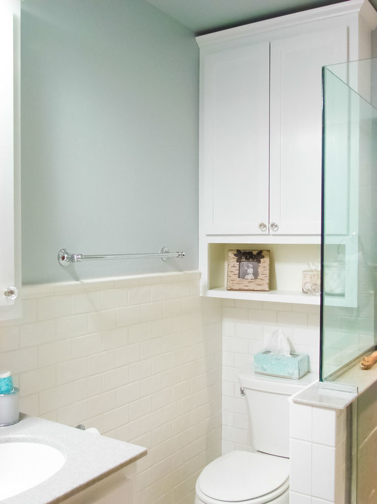 Inspiration for a mid-sized transitional 3/4 white tile and subway tile corner shower remodel with a two-piece toilet, blue walls, an undermount sink, shaker cabinets, white cabinets and quartz countertops