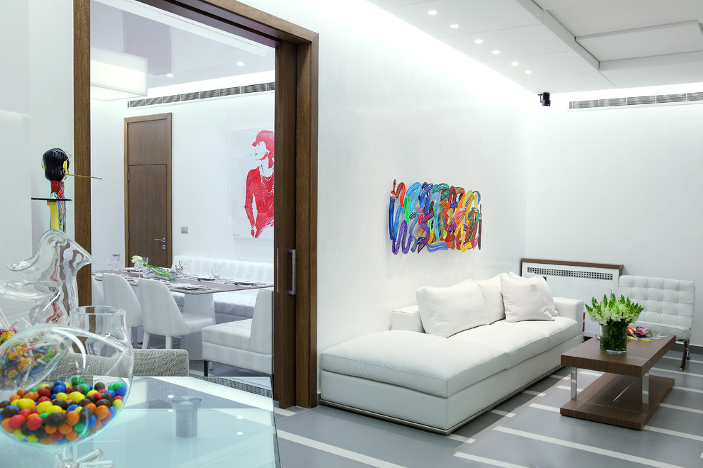 This is an example of a contemporary living room in Other with white walls.