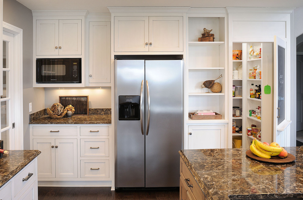 Inspiration for a traditional kitchen in Cleveland with shaker cabinets, white cabinets and stainless steel appliances.
