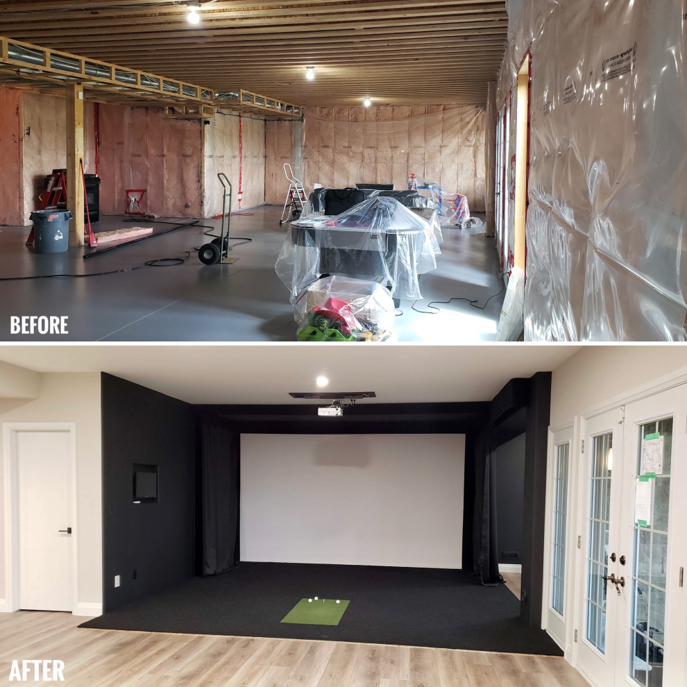 Example of a large transitional walk-out black floor basement game room design