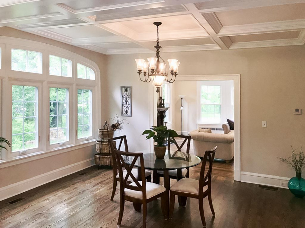 Inspiration for a traditional dining room in Cleveland with grey walls, dark hardwood floors, brown floor and coffered.