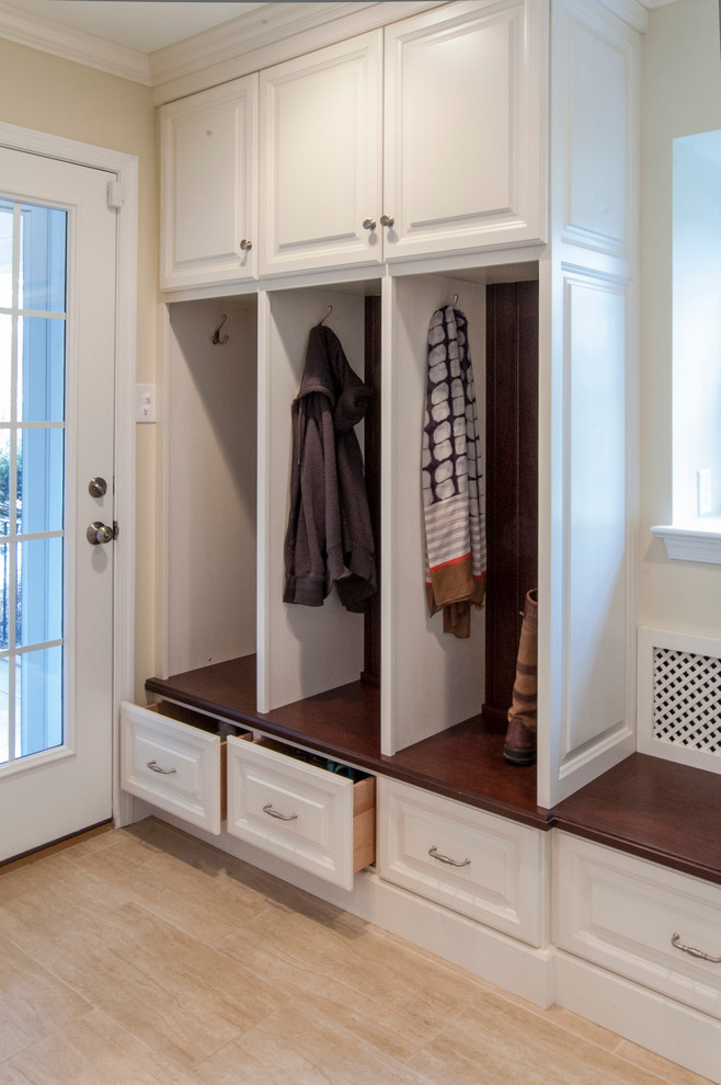 This is an example of a mid-sized traditional mudroom in Philadelphia with yellow walls and light hardwood floors.
