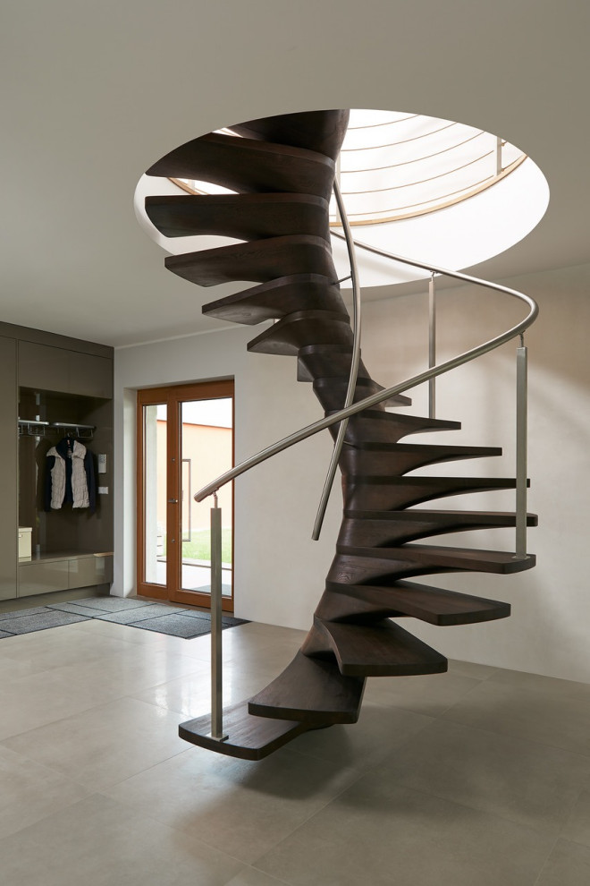 Large modern wood spiral staircase in Miami with metal railing.