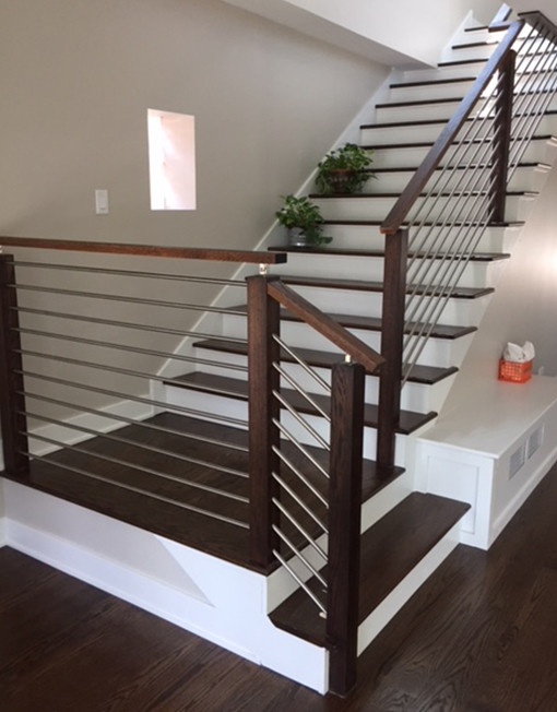 This is an example of a mid-sized modern staircase in Houston.