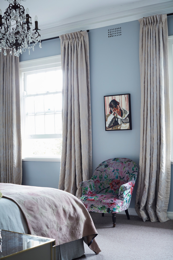 Photo of a large eclectic master bedroom in Sydney with blue walls, carpet, no fireplace and beige floor.