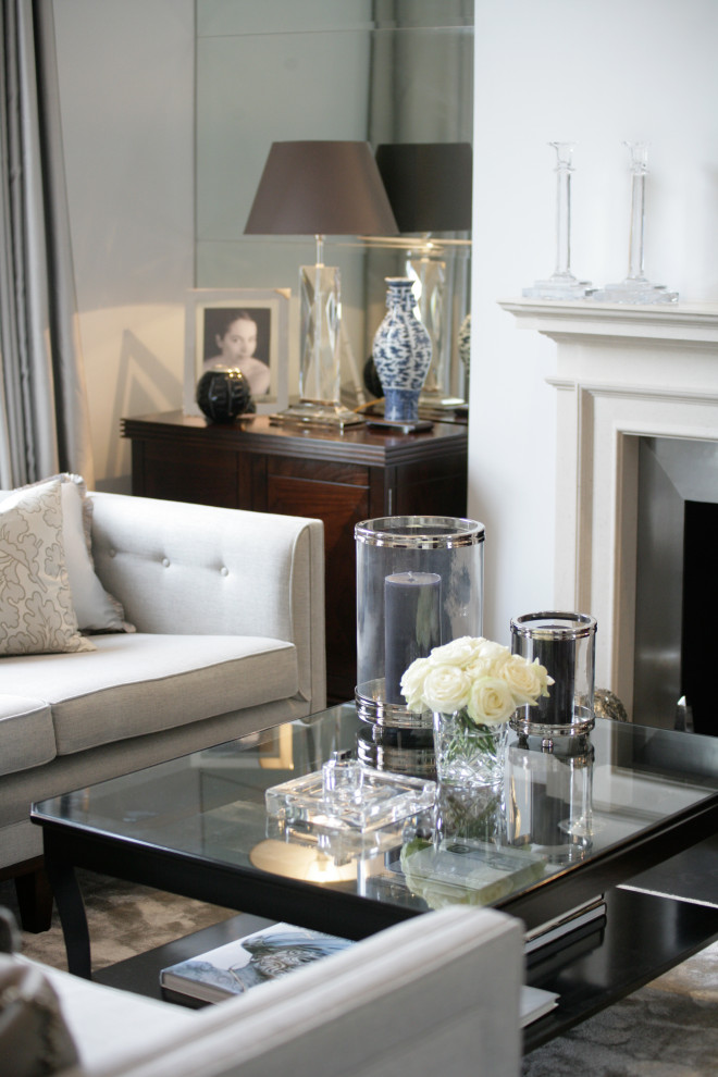 This is an example of an expansive traditional open plan living room in London with light hardwood flooring, no fireplace, no tv and beige floors.