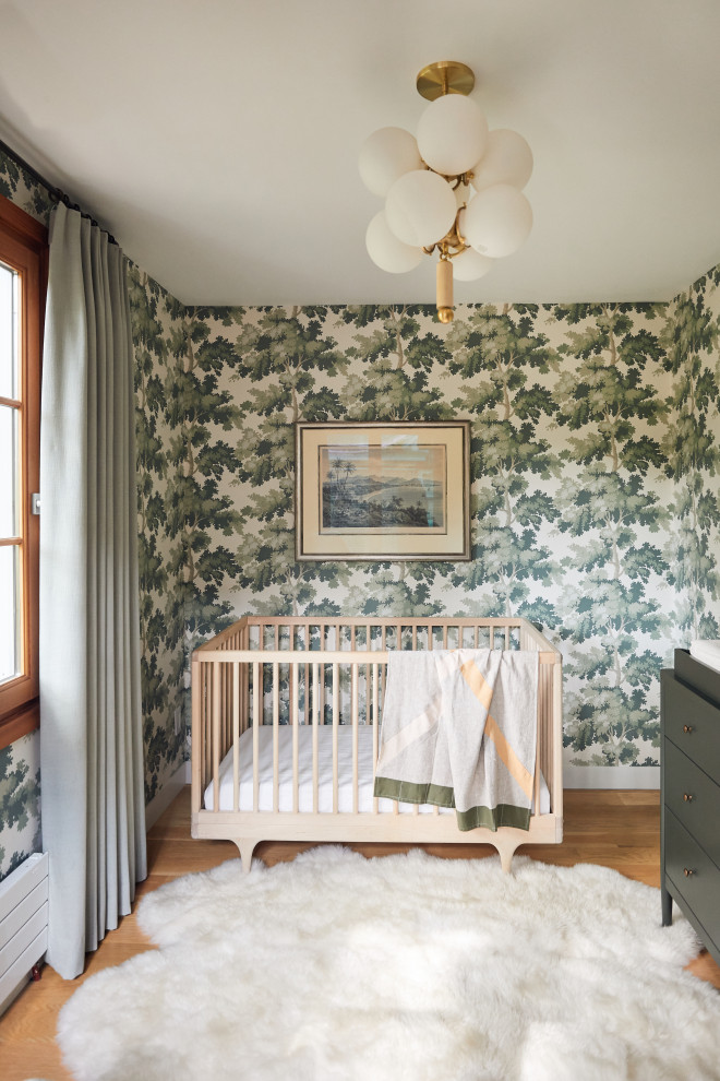 Design ideas for a mid-sized contemporary gender-neutral nursery in Minneapolis with multi-coloured walls, medium hardwood floors and beige floor.