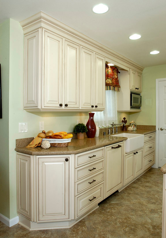 Inspiration for a country u-shaped eat-in kitchen in Sacramento with an integrated sink, raised-panel cabinets, white cabinets, quartzite benchtops, beige splashback, stone slab splashback, panelled appliances and no island.