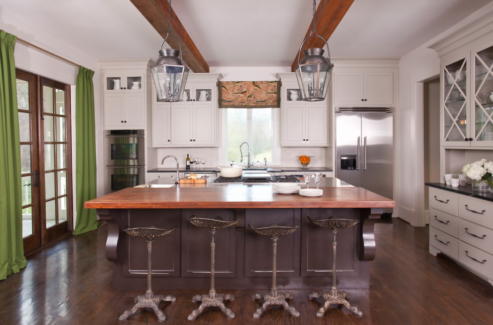 Example of a large transitional galley medium tone wood floor eat-in kitchen design in Atlanta with a farmhouse sink, white backsplash, stainless steel appliances and an island