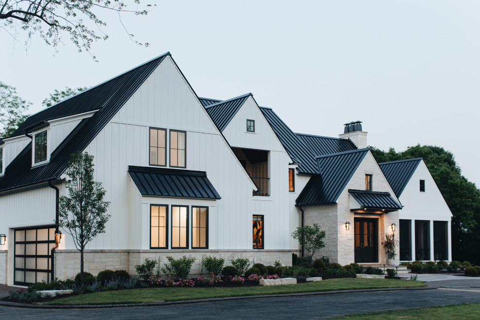 Design ideas for a large transitional white house exterior in Chicago with a black roof.