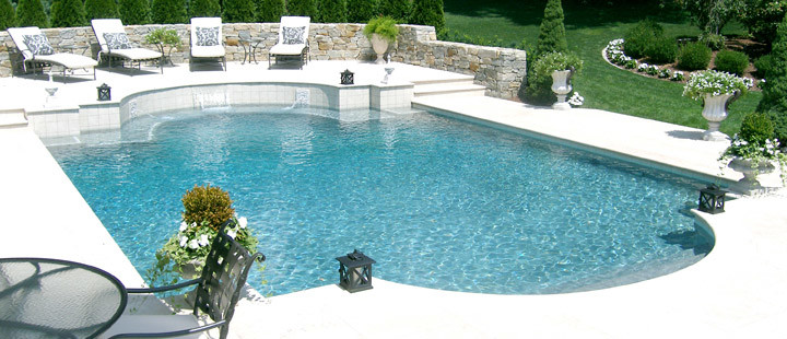 Design ideas for a large modern backyard custom-shaped pool in New York with a hot tub and stamped concrete.