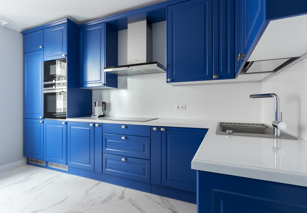 Inspiration for a mid-sized contemporary l-shaped separate kitchen in Moscow with a drop-in sink, raised-panel cabinets, blue cabinets, quartz benchtops, white splashback, stone slab splashback, black appliances, marble floors, no island, white floor and white benchtop.