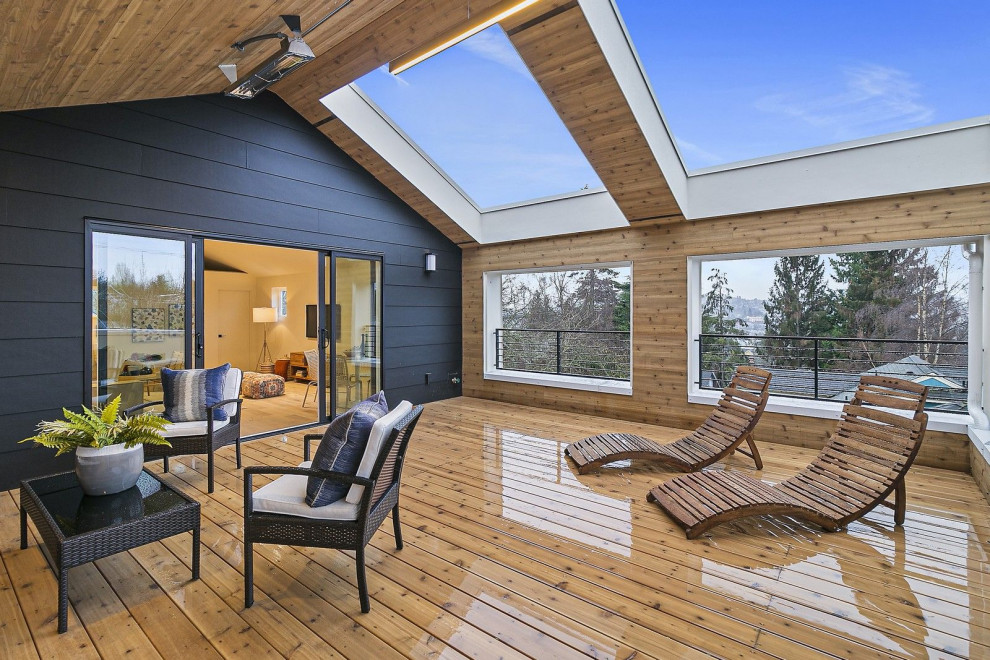 Photo of a large scandinavian roof private and rooftop mixed railing terrace in Seattle with a roof extension.