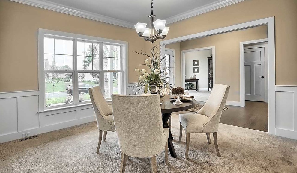 This is an example of a large traditional separate dining room in Other with grey walls and carpet.