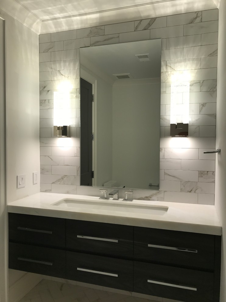 Bathroom - mid-sized modern master black and white tile and porcelain tile bathroom idea in Detroit with raised-panel cabinets, black cabinets, an undermount tub, an undermount sink and quartzite countertops