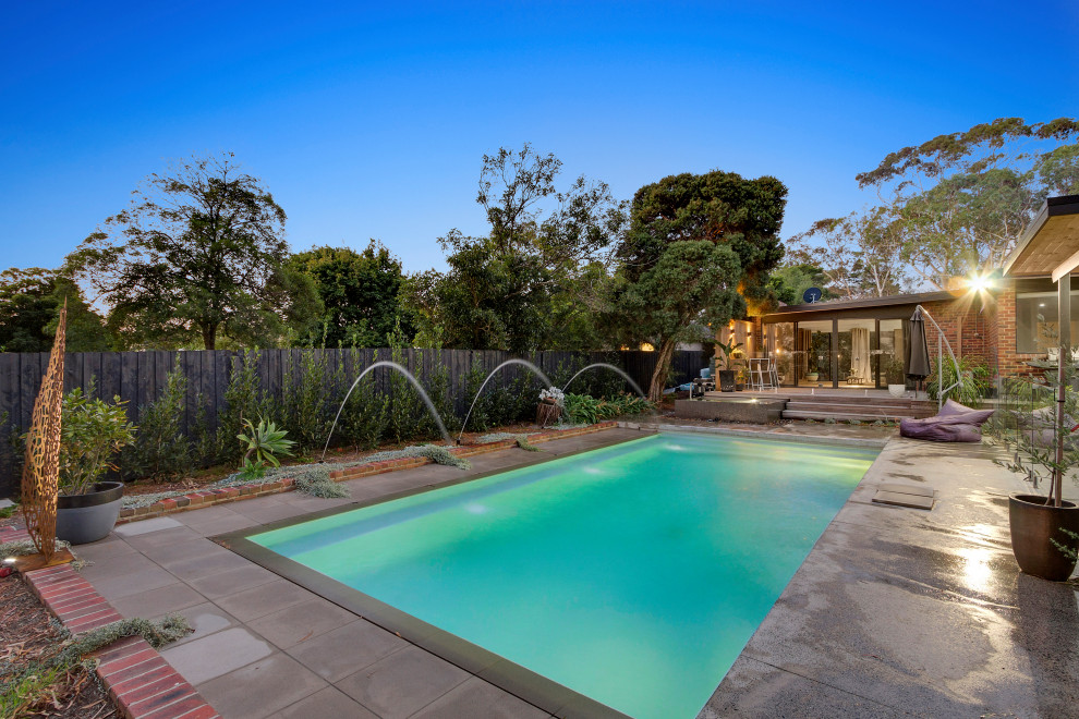 Transitional rectangular pool in Melbourne with concrete slab.