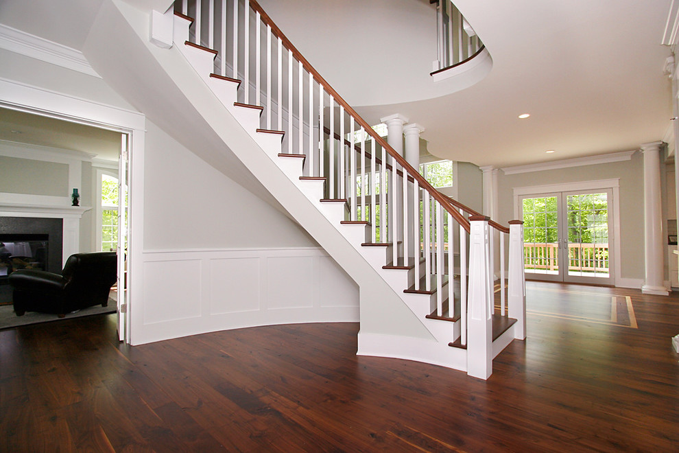 Inspiration for a traditional wood curved staircase in New York with wood risers.