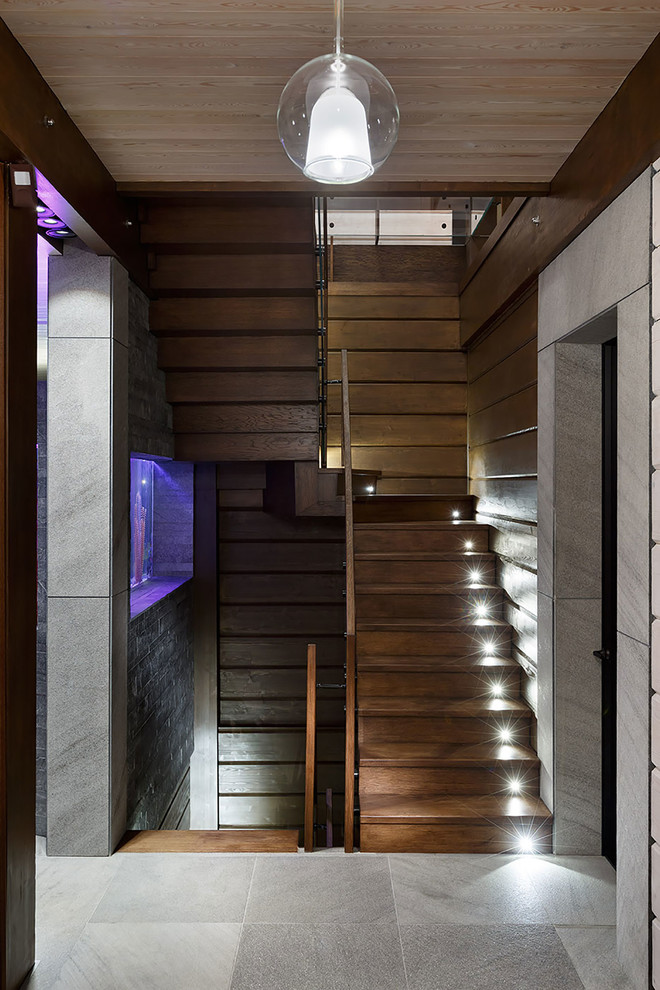 Design ideas for a contemporary wood u-shaped staircase in Saint Petersburg with wood risers.