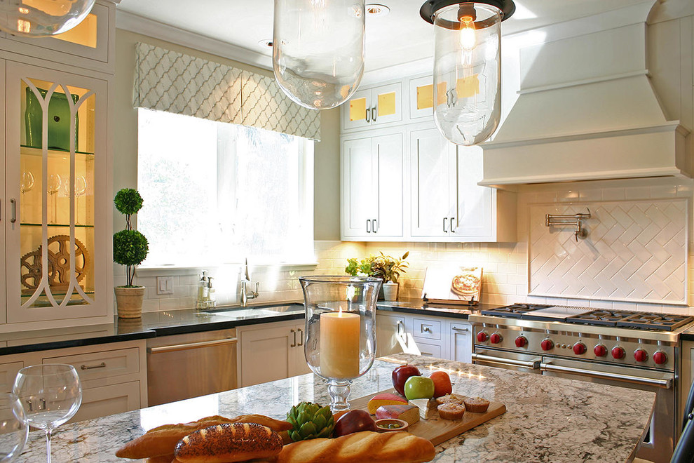Example of a large transitional medium tone wood floor kitchen design in Houston with an undermount sink, recessed-panel cabinets and an island