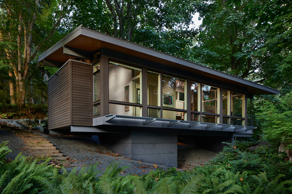 This is an example of a modern one-storey brown house exterior in Seattle with a flat roof.