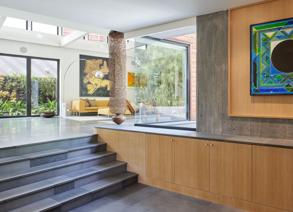 This is an example of a modern entrance in San Francisco with grey walls, slate flooring and grey floors.