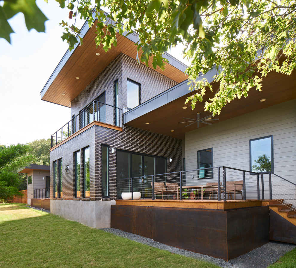 Design ideas for a contemporary two-storey multi-coloured house exterior in Austin with mixed siding.