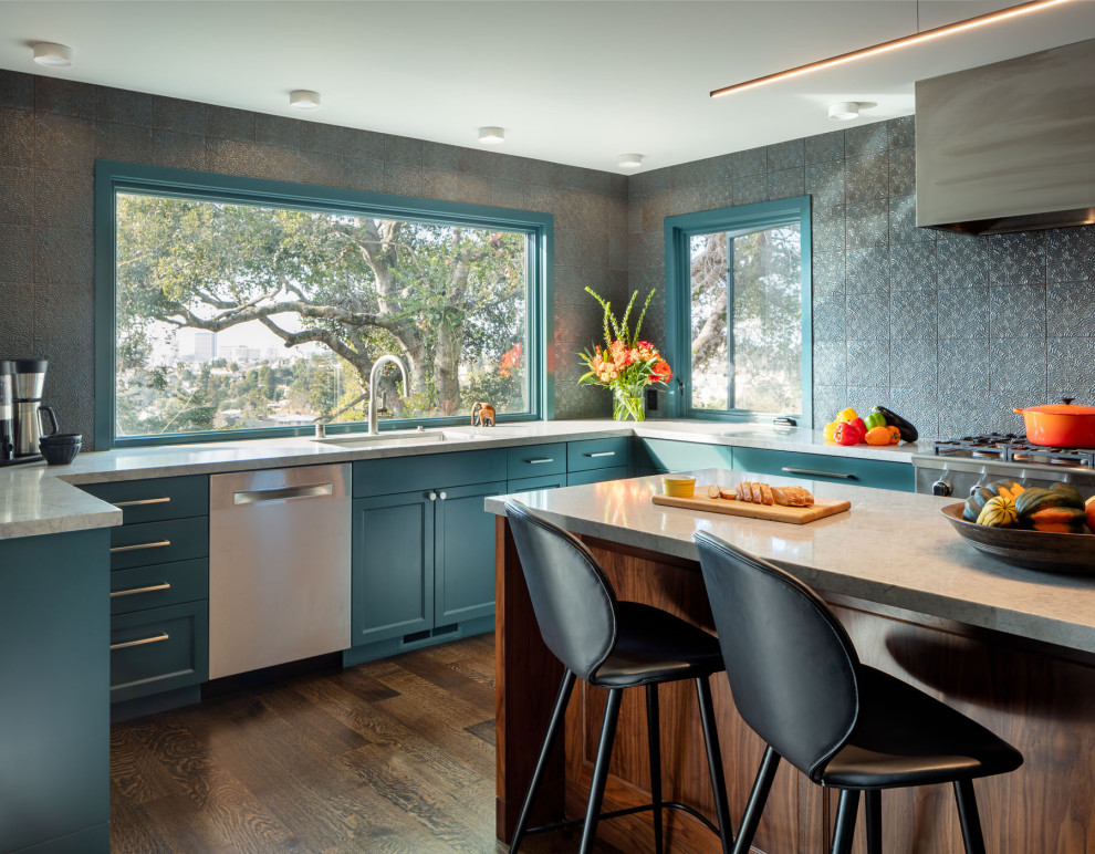 Kitchen - huge transitional u-shaped dark wood floor kitchen idea in San Francisco with an undermount sink, shaker cabinets, blue cabinets, solid surface countertops, blue backsplash, ceramic backsplash, stainless steel appliances, an island and gray countertops