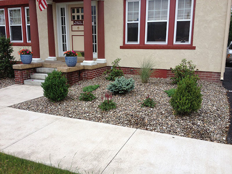 Photo of a front yard gravel formal garden.