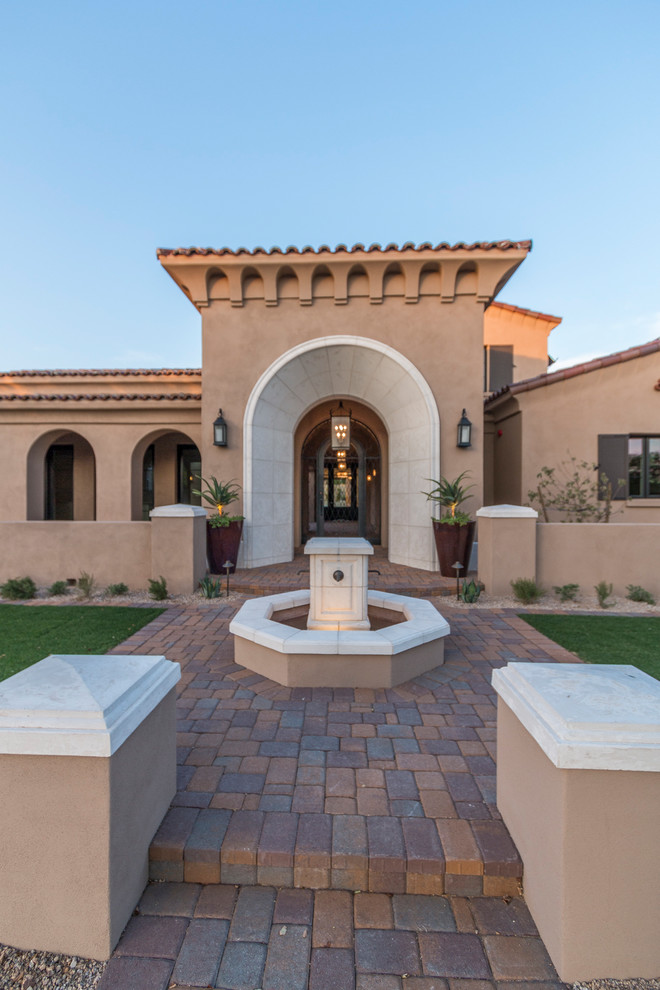Inspiration for a huge transitional beige two-story stucco house exterior remodel in Phoenix with a tile roof