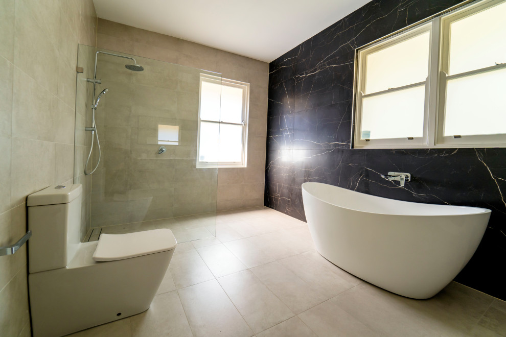 На фото: большая главная ванная комната в современном стиле с отдельно стоящей ванной, угловым душем, унитазом-моноблоком, черно-белой плиткой, керамической плиткой, белыми стенами, полом из керамической плитки, белым полом и тумбой под две раковины с
