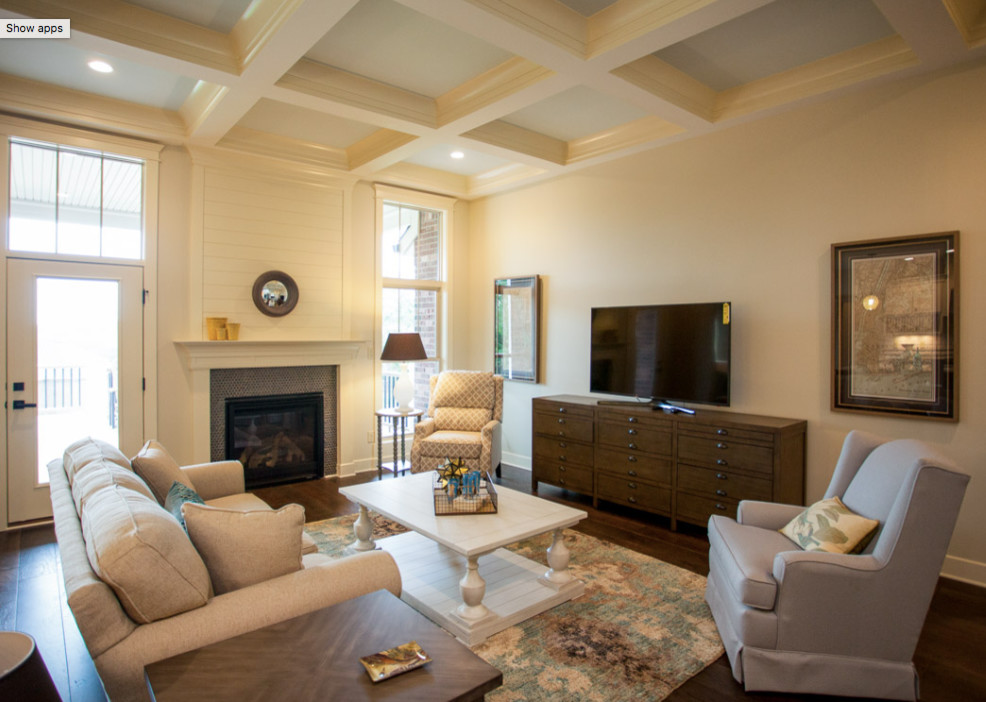 Inspiration for a mid-sized beach style formal open concept living room in Orange County with beige walls, medium hardwood floors, a standard fireplace, a wood fireplace surround and a freestanding tv.