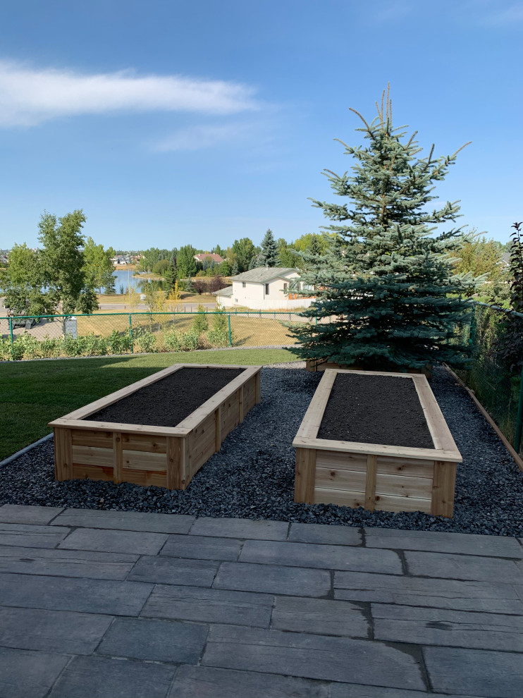 Photo of a medium sized classic side xeriscape full sun garden for summer in Calgary with a potted garden, decking and a metal fence.