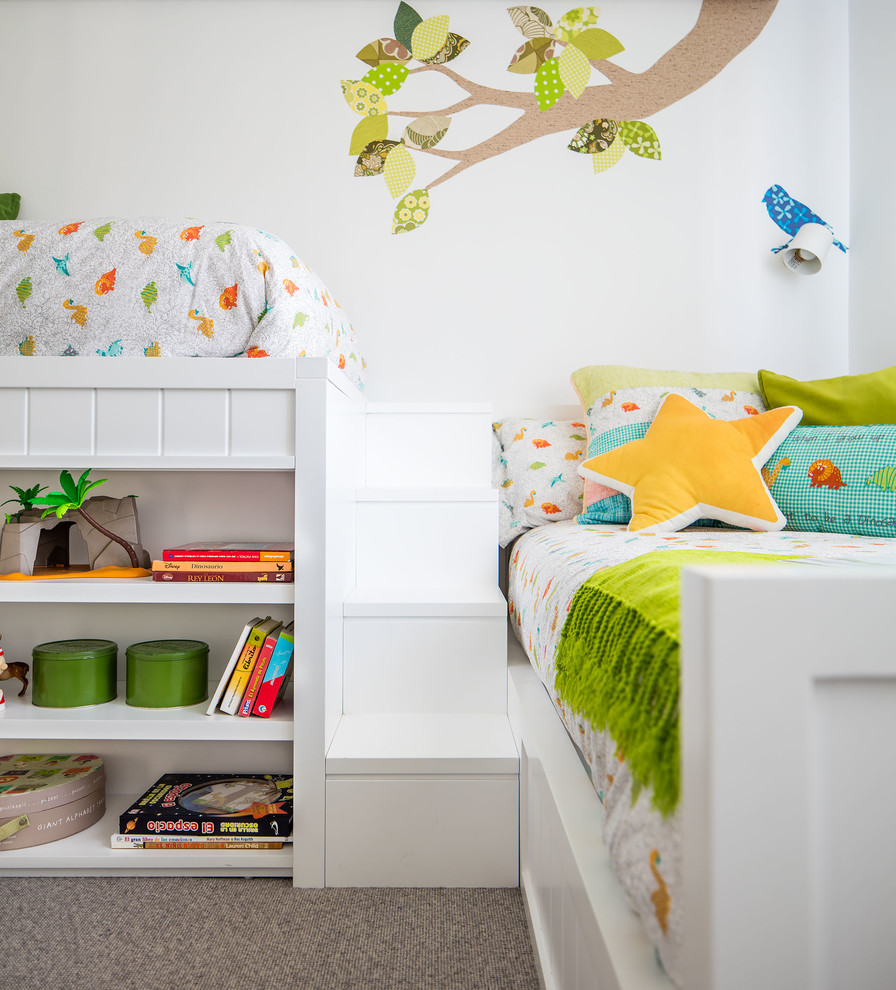 This is an example of a small contemporary gender-neutral kids' bedroom for kids 4-10 years old in Other with white walls, carpet and grey floor.