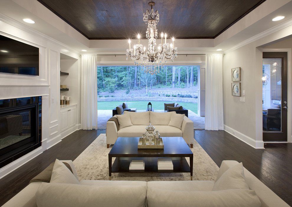 Inspiration for an eclectic formal open concept living room in Atlanta with white walls, dark hardwood floors, a standard fireplace, a metal fireplace surround, a wall-mounted tv and brown floor.