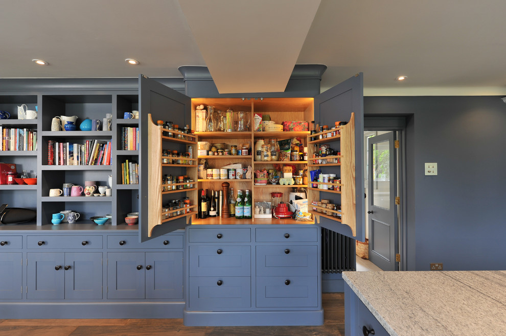 Design ideas for a large transitional kitchen pantry in Hampshire with blue cabinets, granite benchtops, with island and shaker cabinets.