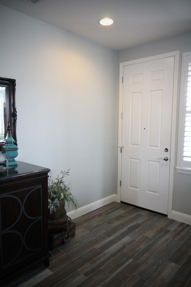 Front door - mid-sized transitional porcelain tile front door idea in Sacramento with gray walls and a white front door